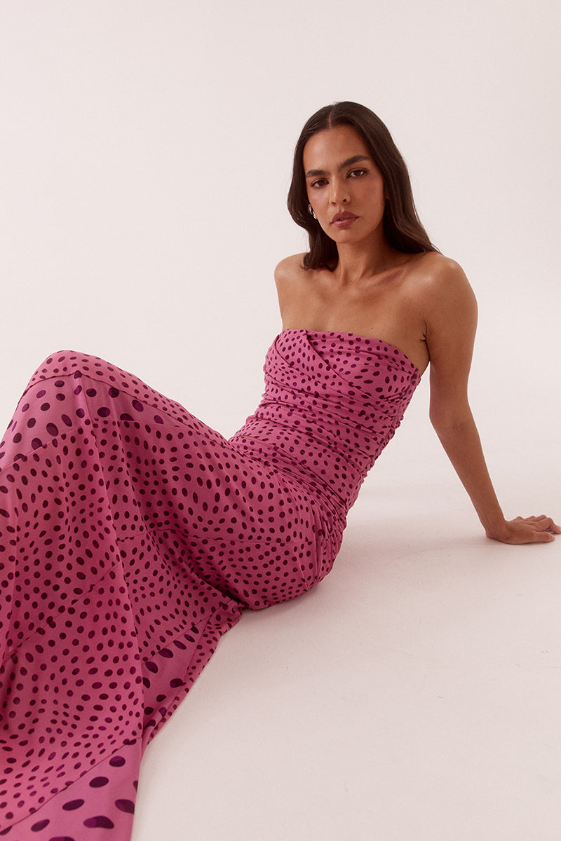 Model wearing an exclusive print strapless stretch mesh top with draped chest panel, gathered waist detailing, and fitted silhouette.