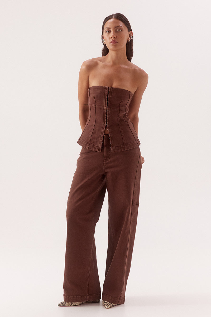 Women's cotton blend denim strapless fitted top with front hook and eye fastening, panel detailing and shaping darts.