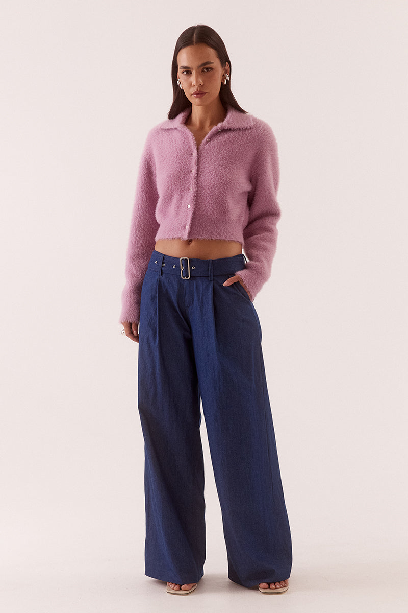Model wearing a fluffy knit cardigan with collar, short buttoned front, long sleeves, dropped shoulders and fitted ribbed hem and cuffs.