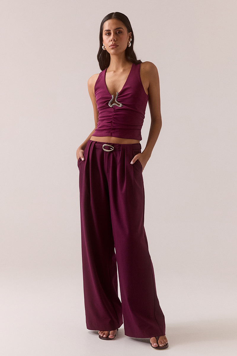 Mid rise wide-leg stretch rayon blend pants with front pleats, removable belt with silver buckle, angled front pockets and back welt pockets.
