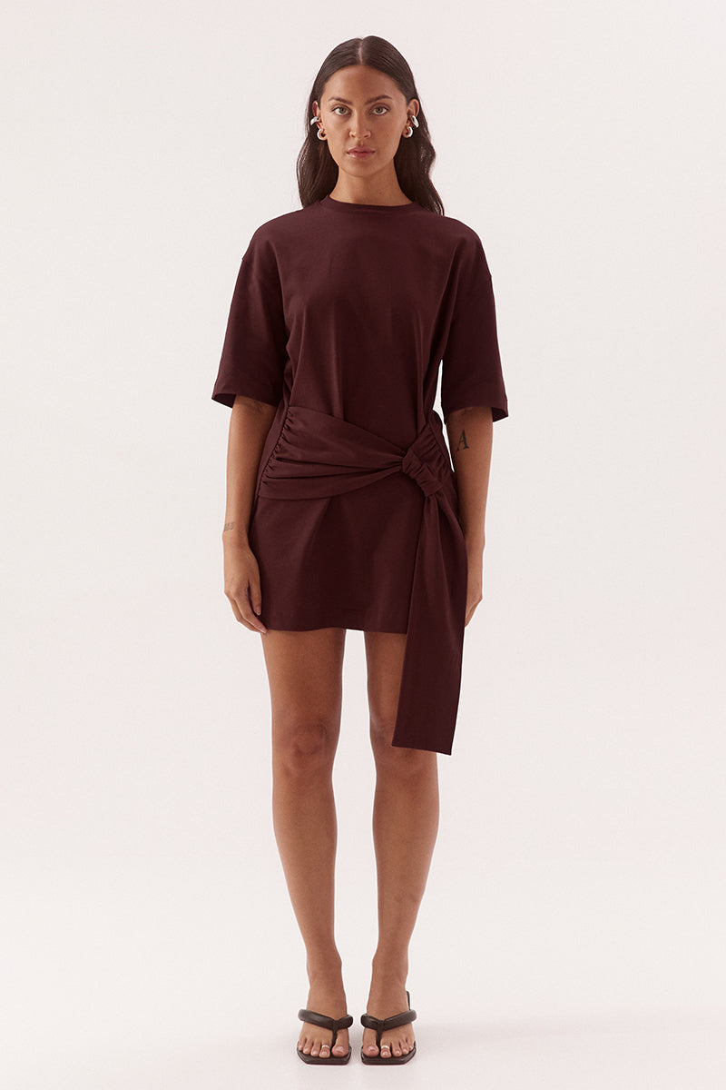 Relaxed fit 100% cotton mini T-shirt dress with crew neckline, dropped shoulders, side-gathered sash with loop detail, worn by model in size 8.