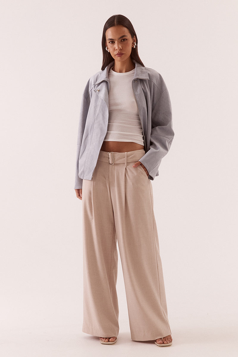 Women’s faux suede bomber jacket with dropped shoulders, front zip closure, welt pockets, chest zip detail, and elasticated hem finish.