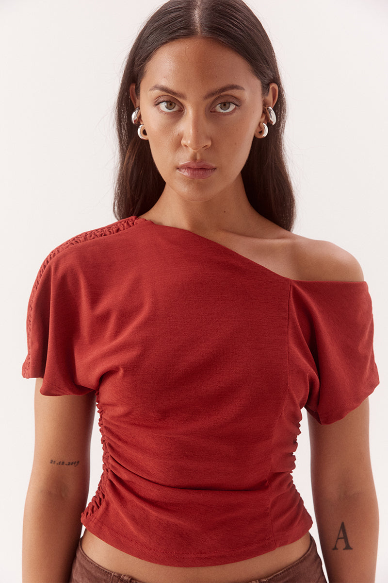 Textured mesh off shoulder top with asymmetric neckline, gathered waist, short sleeves and versatile shoulder styling