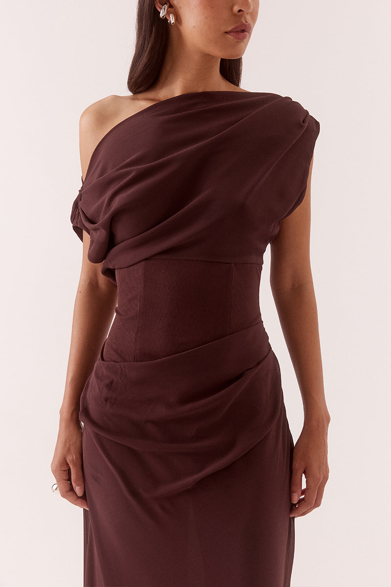Women’s A-line maxi dress with chiffon upper, textured stretch waistband, draped overlayer skirt, boat neck neckline, long sleeves, and side zip closure.