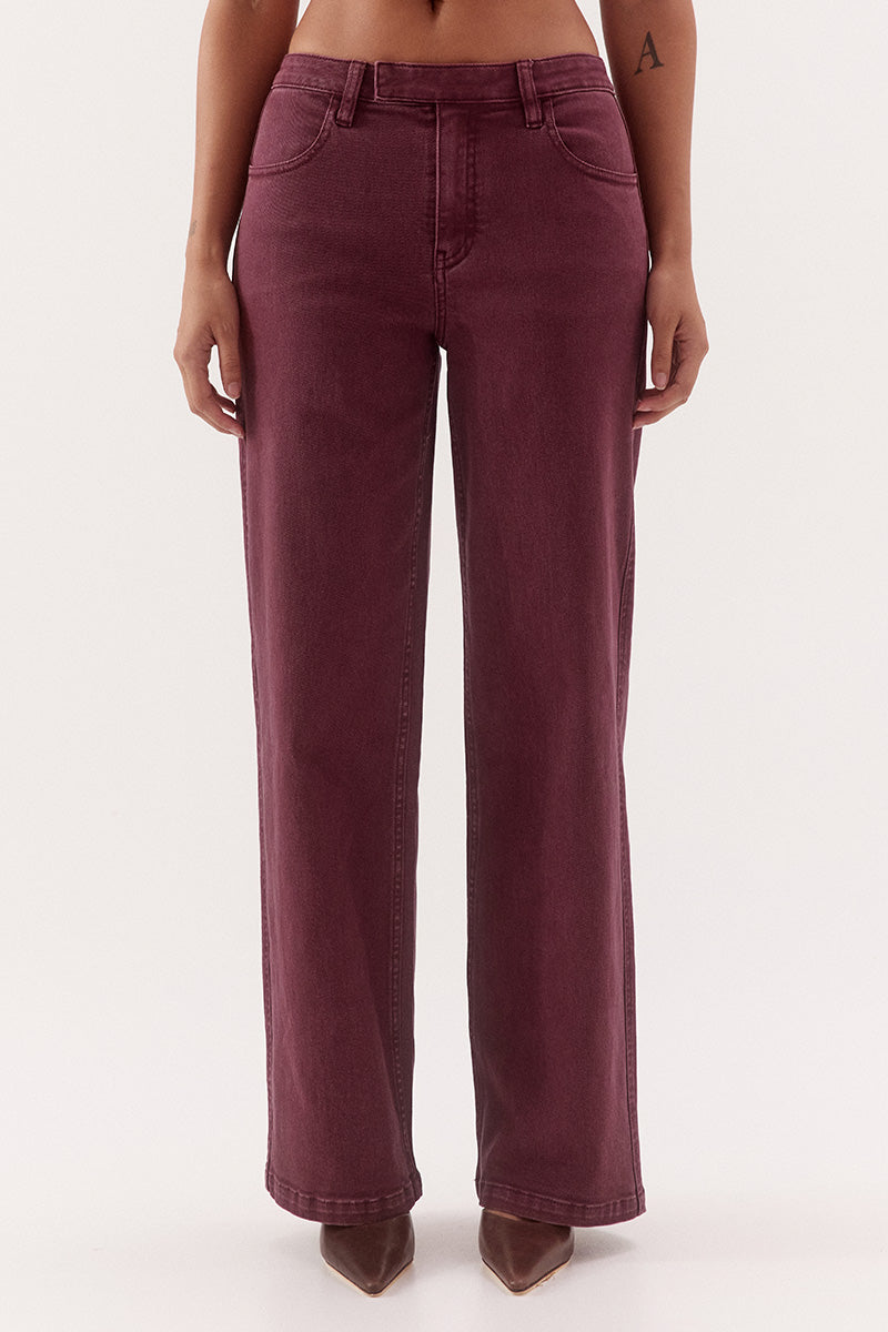Women's mid-rise straight leg jeans in cotton blend denim with functional front and back pockets, fly-front closure, and tailored hem darts.