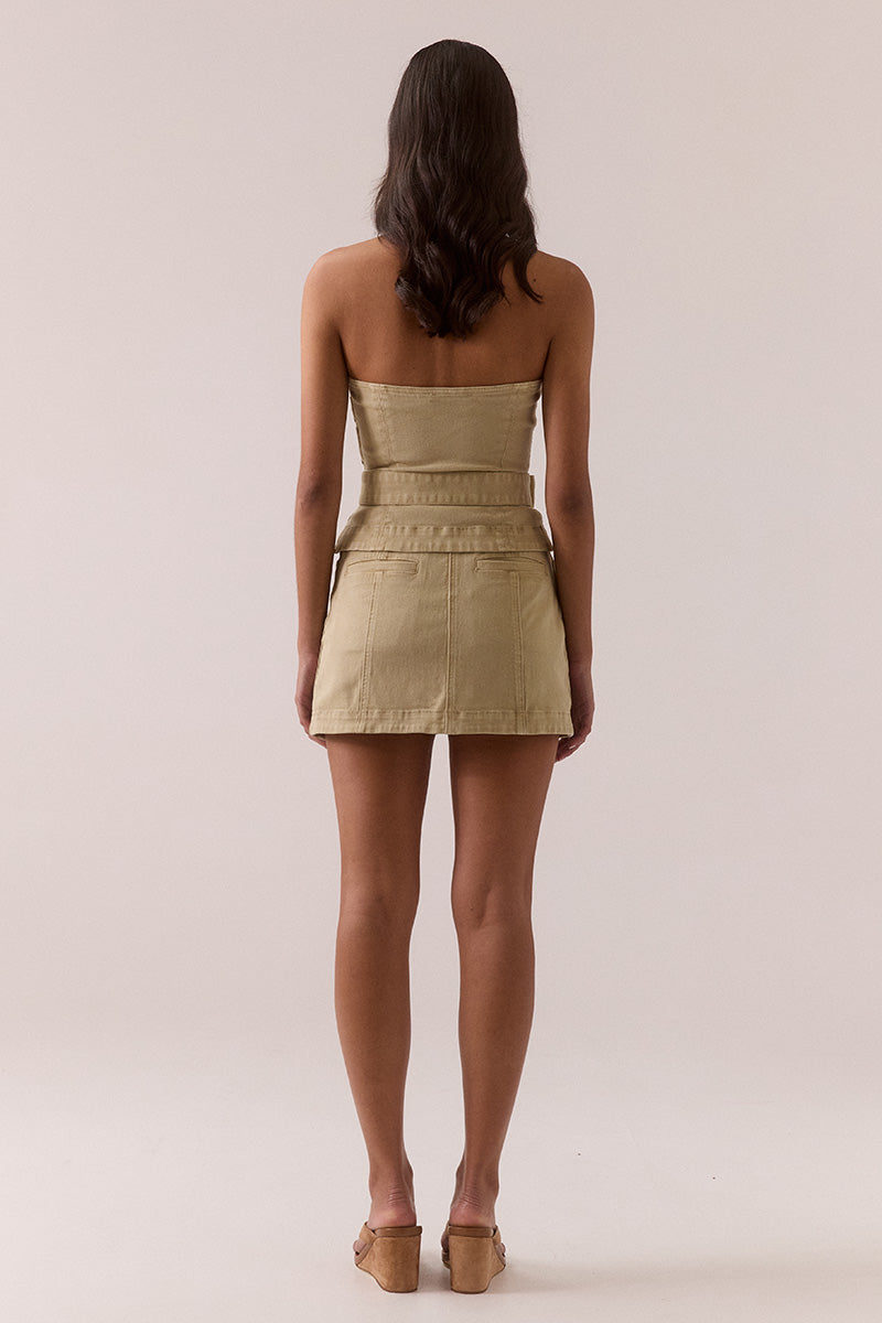 Women’s fitted strapless denim top with panel shaping, side seam zipper, removable hip belt, and left side split.
