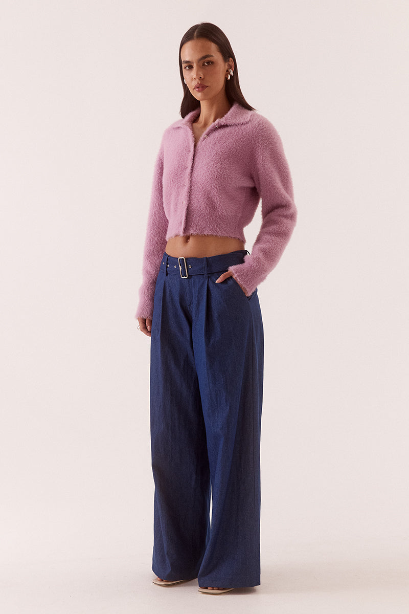 Model wearing a fluffy knit cardigan with collar, short buttoned front, long sleeves, dropped shoulders and fitted ribbed hem and cuffs.