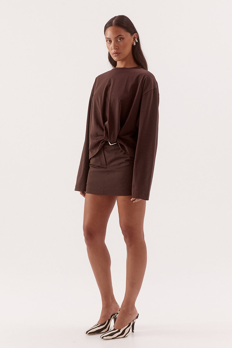 Women's oversized cotton long sleeve tee with dropped shoulders, crew neckline, and tucked front detail creating a flattering shaped hem.