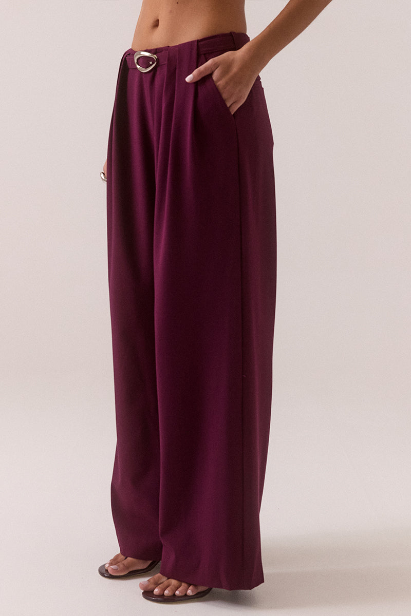 Mid rise wide-leg stretch rayon blend pants with front pleats, removable belt with silver buckle, angled front pockets and back welt pockets.