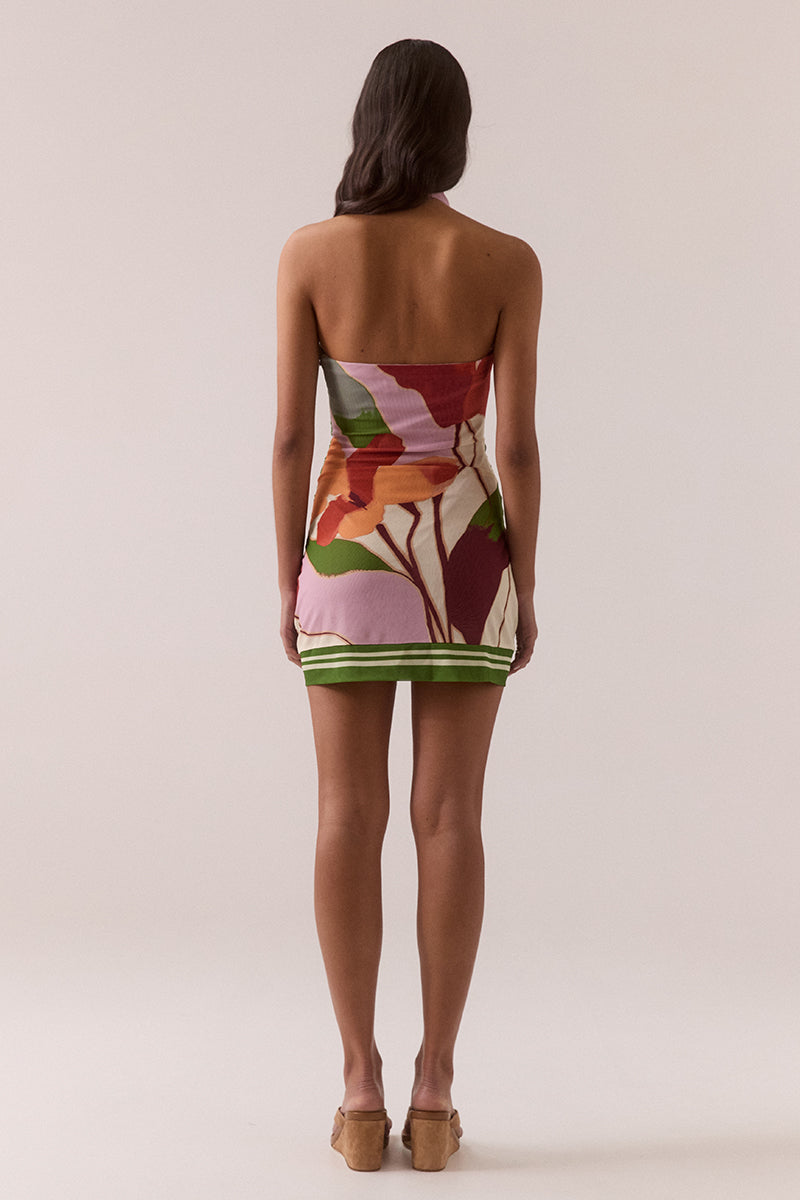 Fitted halter neck mini dress with exclusive placement print, stretch mesh fabric, front cowl neckline, side waist ties and invisible side zipper, worn by model in size 8.