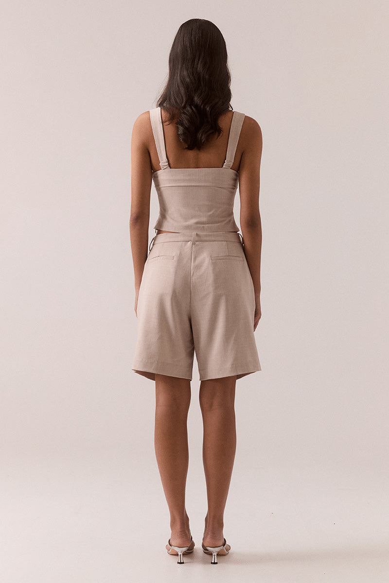 Women’s fitted top in stretchy rayon blend with balconette neckline, layered tuck details, wide adjustable straps, deep underbust tuck, and back zipper closure.