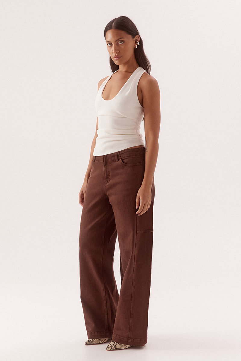 Women's viscose blend sleeveless top with deep scoop neckline, racer back, shoulder tucks, asymmetric hem and stretch lining.