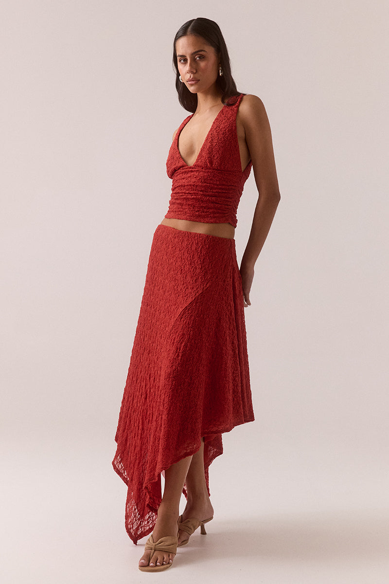 Fitted plunge neckline stretch lace top with empire line design, side gathers and pull-on fit, fully lined and worn by model in size 8.