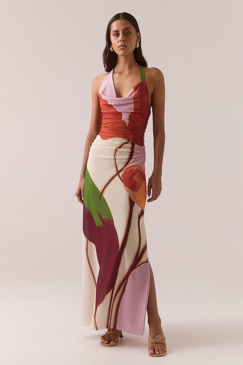 Fitted halter neck maxi dress in stretch mesh with exclusive placement print, asymmetric cowl neckline, side gathers, left leg split and invisible side zipper, worn by model in size 8.