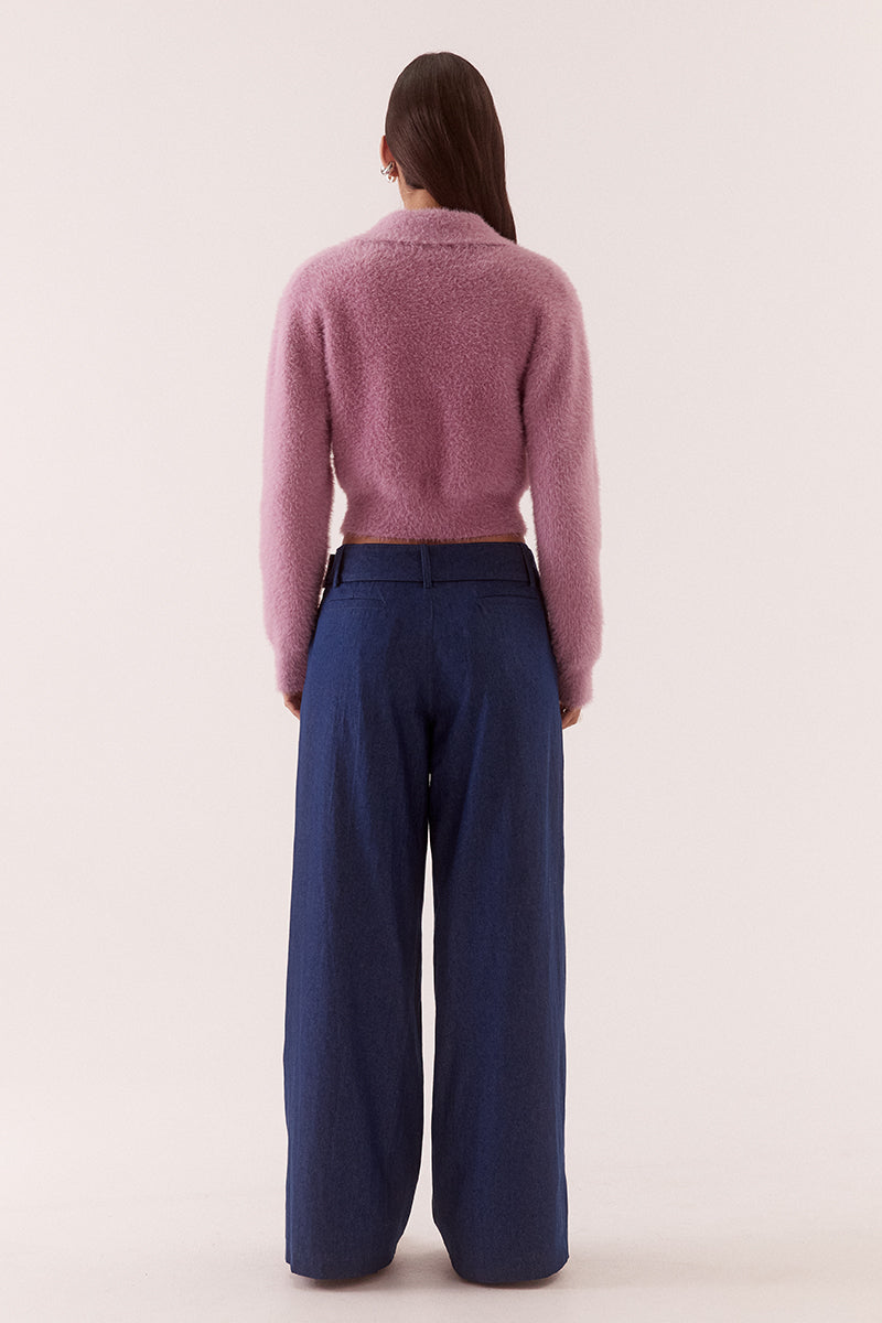 Model wearing a fluffy knit cardigan with collar, short buttoned front, long sleeves, dropped shoulders and fitted ribbed hem and cuffs.