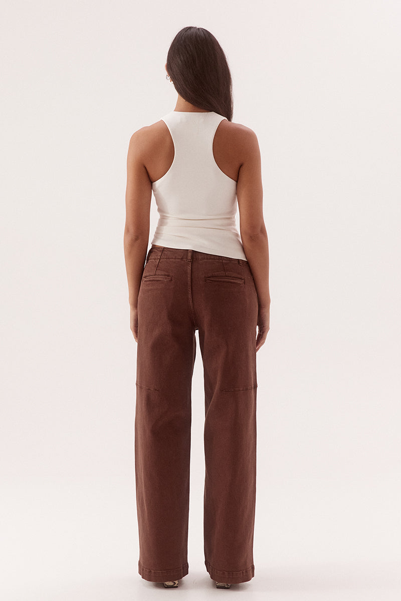 Women's viscose blend sleeveless top with deep scoop neckline, racer back, shoulder tucks, asymmetric hem and stretch lining.