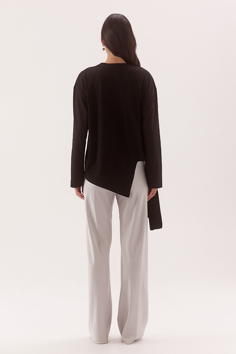 Women's oversized long sleeve cotton tee with dropped shoulders, crew neck, tie-side detail, and relaxed fit. Model wears size 8 and is 178cm tall.