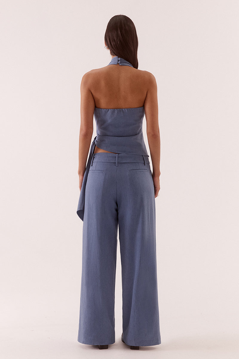 Women’s halter neck top in stretch rayon blend with wrap design, asymmetric hem, sash detail, elasticated back, and side zip closure.