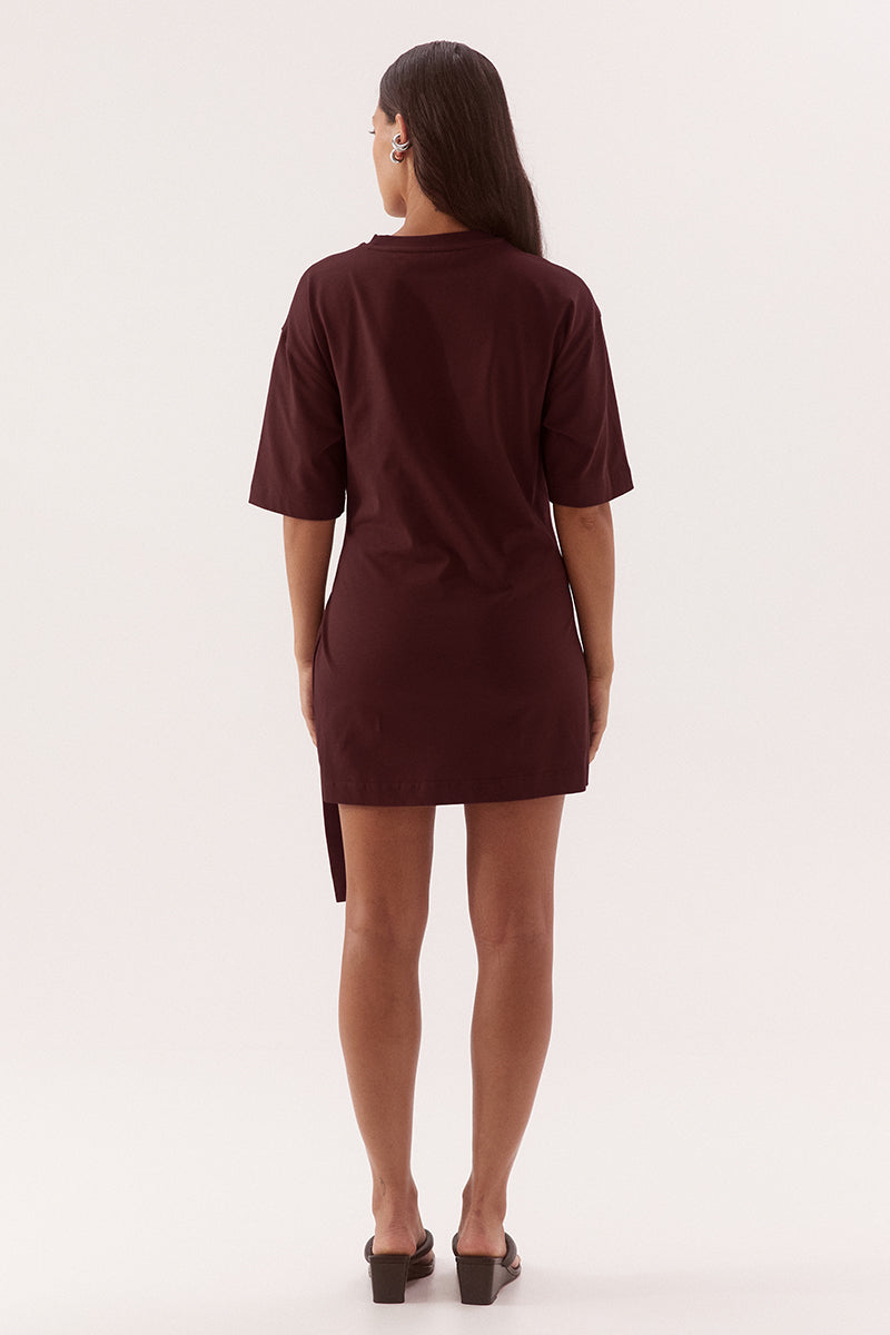 Relaxed fit 100% cotton mini T-shirt dress with crew neckline, dropped shoulders, side-gathered sash with loop detail, worn by model in size 8.