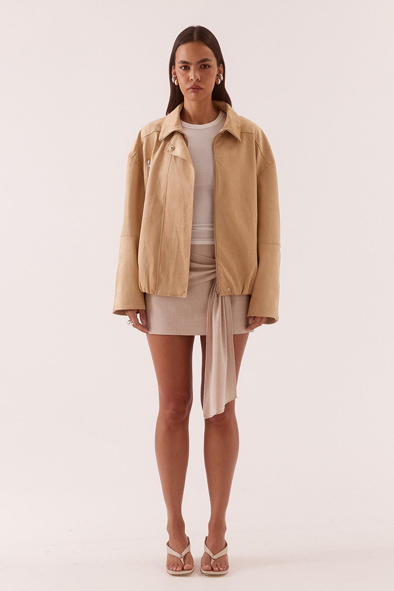 Women’s faux suede bomber jacket with dropped shoulders, front zip closure, welt pockets, chest zip detail, and elasticated hem finish.