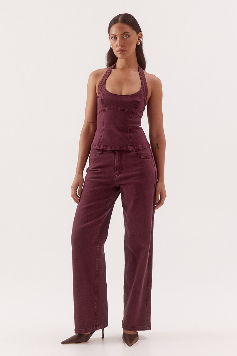 Women's cotton blend denim halter mini dress with scoop neckline, empire waist, princess seam detailing, and open-back zip closure.