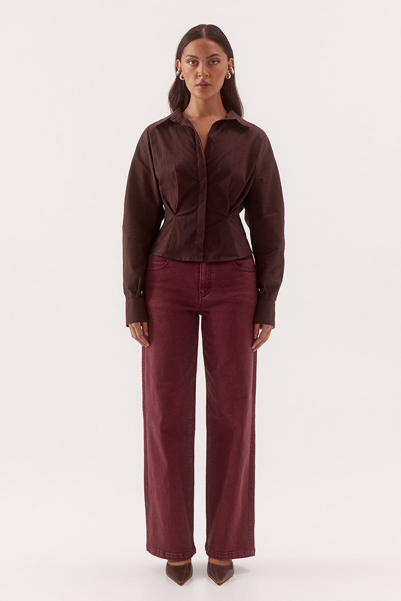 Women's cotton blend long sleeve shirt with a cinched waist, barrel sleeves, concealed button front, two-piece collar, and shaping seam details.
