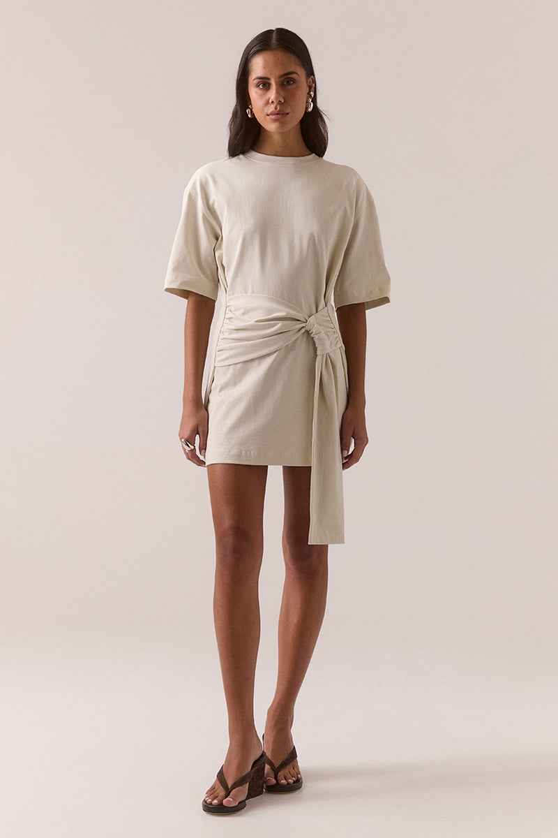 Relaxed fit 100% cotton mini T-shirt dress with crew neckline, dropped shoulders, side-gathered sash with loop detail, worn by model in size 8.