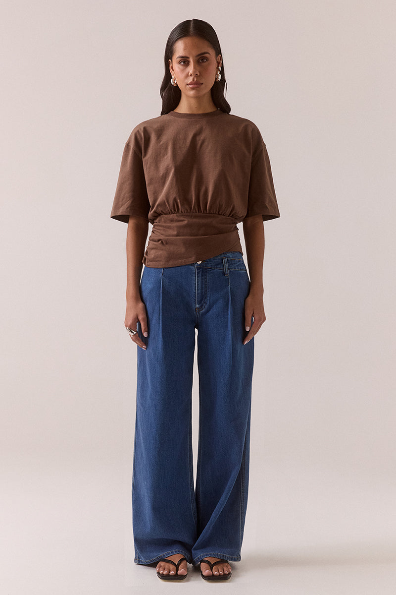 Fitted plunge neckline stretch lace top with empire line design, side gathers and pull-on fit, fully lined and worn by model in size 8.