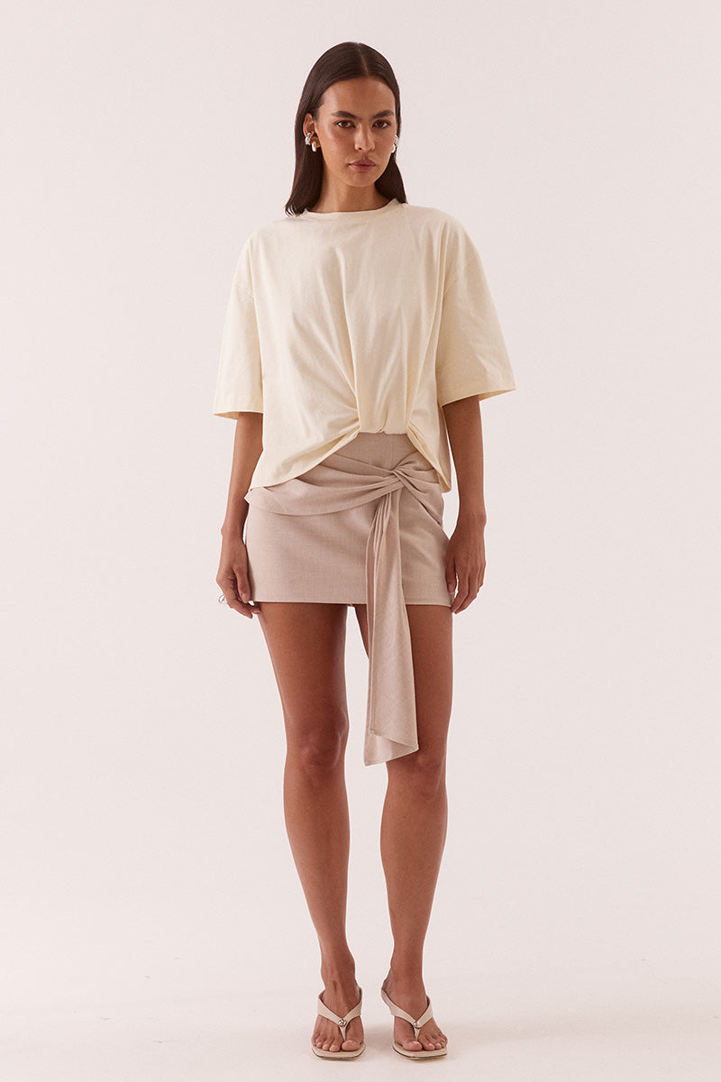 Women’s oversized cotton tee with dropped shoulders, crew neck, mid-length sleeves, and tucked front detail creating a shaped hem.