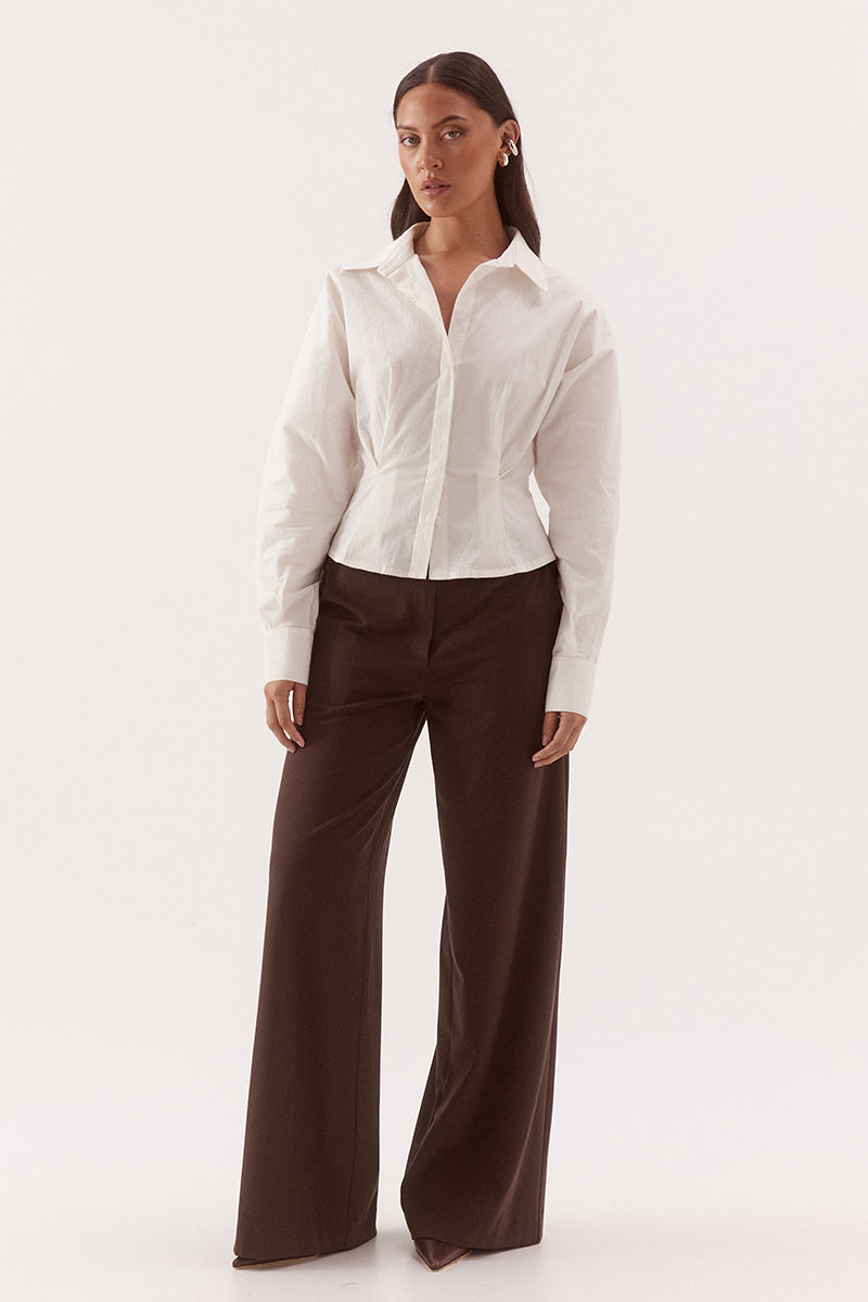 Women's cotton blend long sleeve shirt with a cinched waist, barrel sleeves, concealed button front, two-piece collar, and shaping seam details.