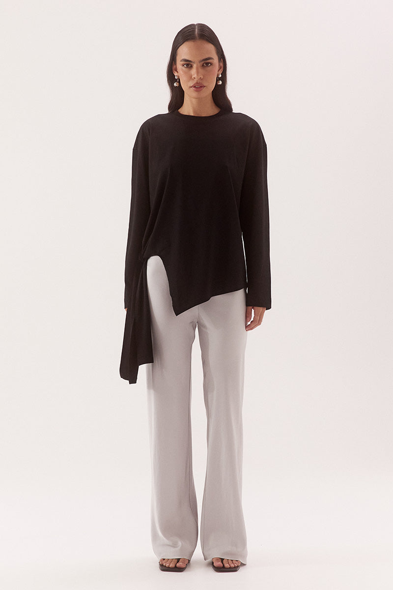 Women's oversized long sleeve cotton tee with dropped shoulders, crew neck, tie-side detail, and relaxed fit. Model wears size 8 and is 178cm tall.