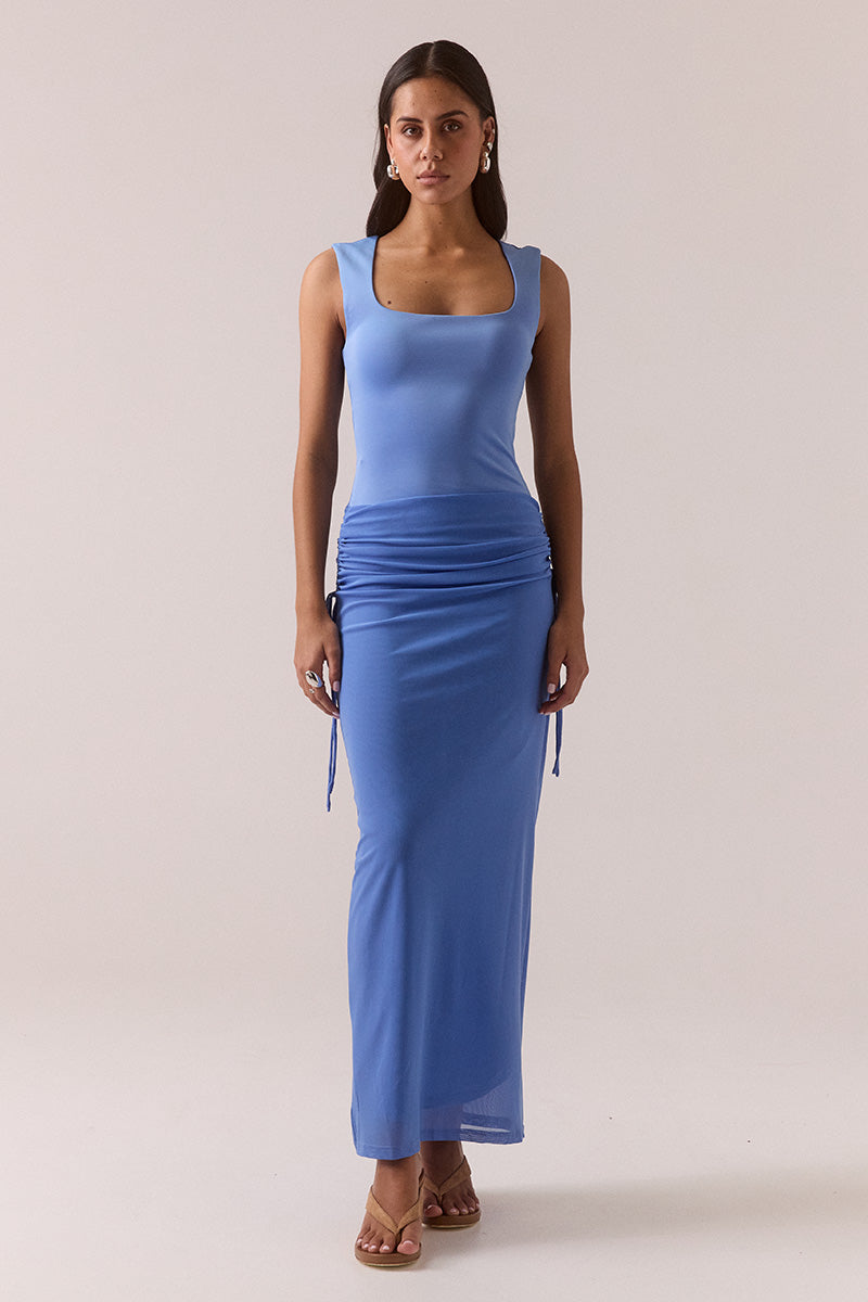 Model wearing dropped waist maxi dress with wide square neckline, stretch bodice, adjustable hip drawstring, fully lined mesh skirt, and elongating pull-on silhouette.