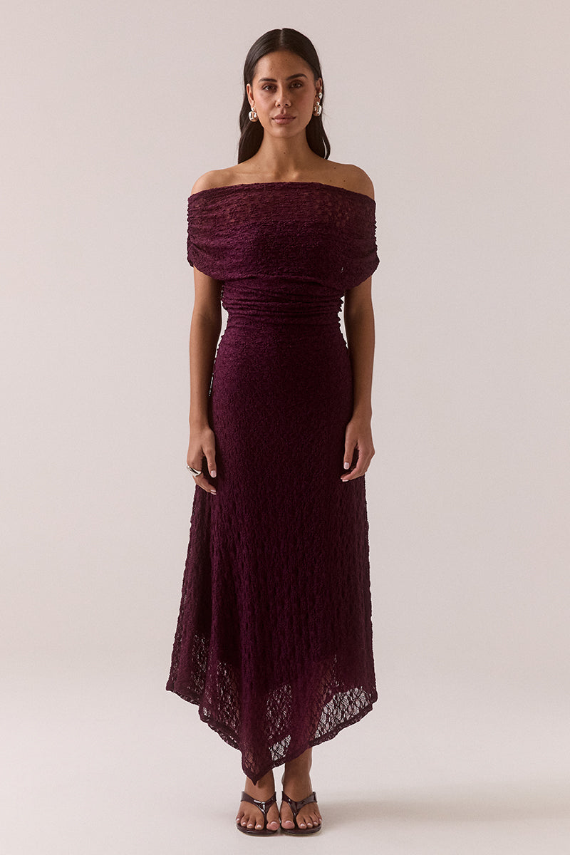 Off shoulder stretch lace midi dress with asymmetric hem, gathered waist and shoulders, internal bralette lining and left side split, worn by model in size 8.