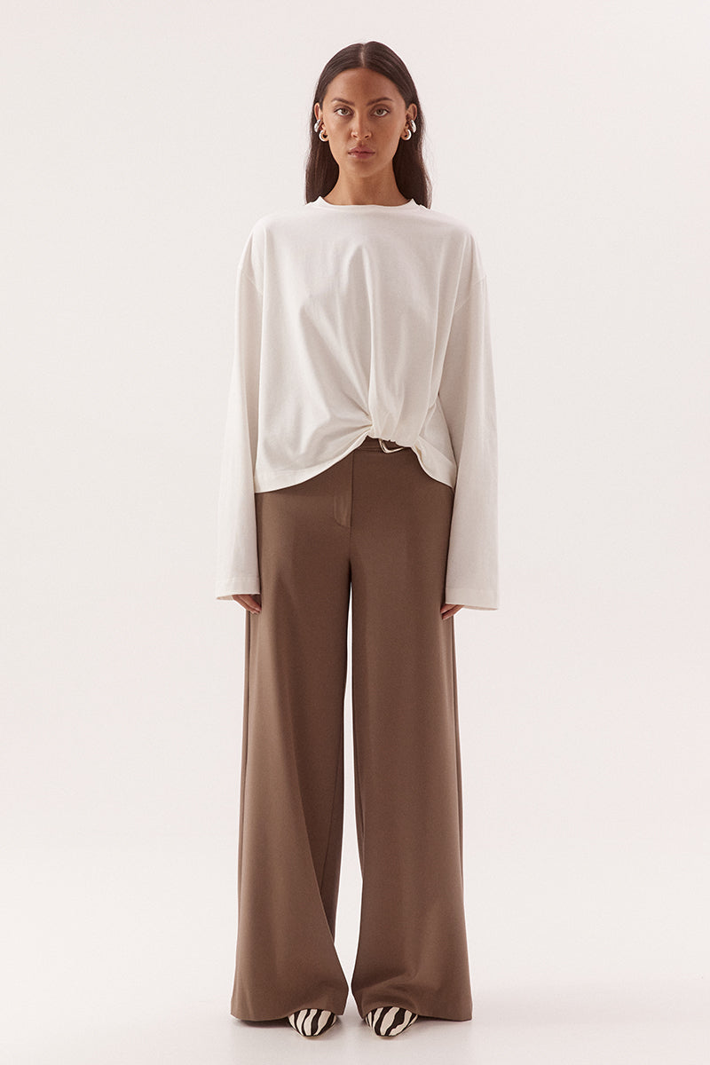 Women's oversized cotton long sleeve tee with dropped shoulders, crew neckline, and tucked front detail creating a flattering shaped hem.