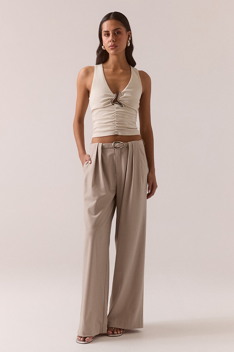 Fitted sleeveless V-neck top in stretchy fabric with silver chest hardware, gathered waist, racer back and pull-on design, fully lined, worn by model in size 8.