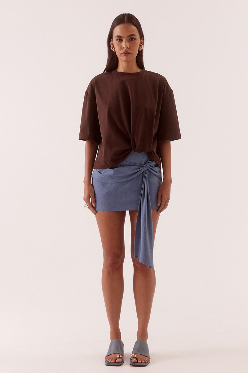 Women’s oversized cotton tee with dropped shoulders, crew neck, mid-length sleeves, and tucked front detail creating a shaped hem.