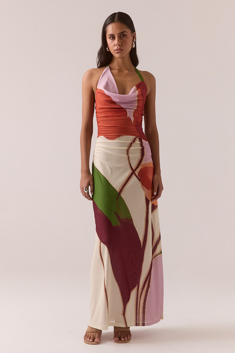 Fitted halter neck maxi dress in stretch mesh with exclusive placement print, asymmetric cowl neckline, side gathers, left leg split and invisible side zipper, worn by model in size 8.