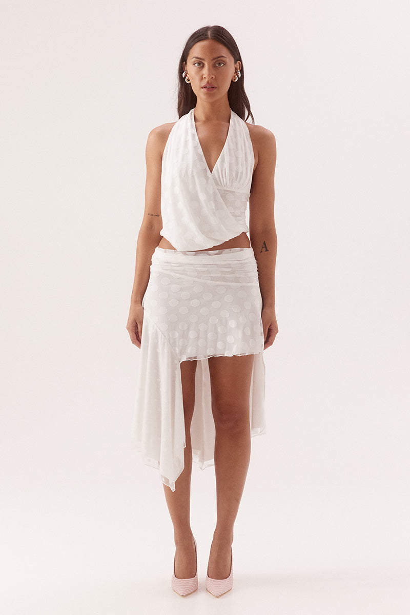 Mid-rise skirt in dot stretch mesh with circle cut side panels and asymmetric hem