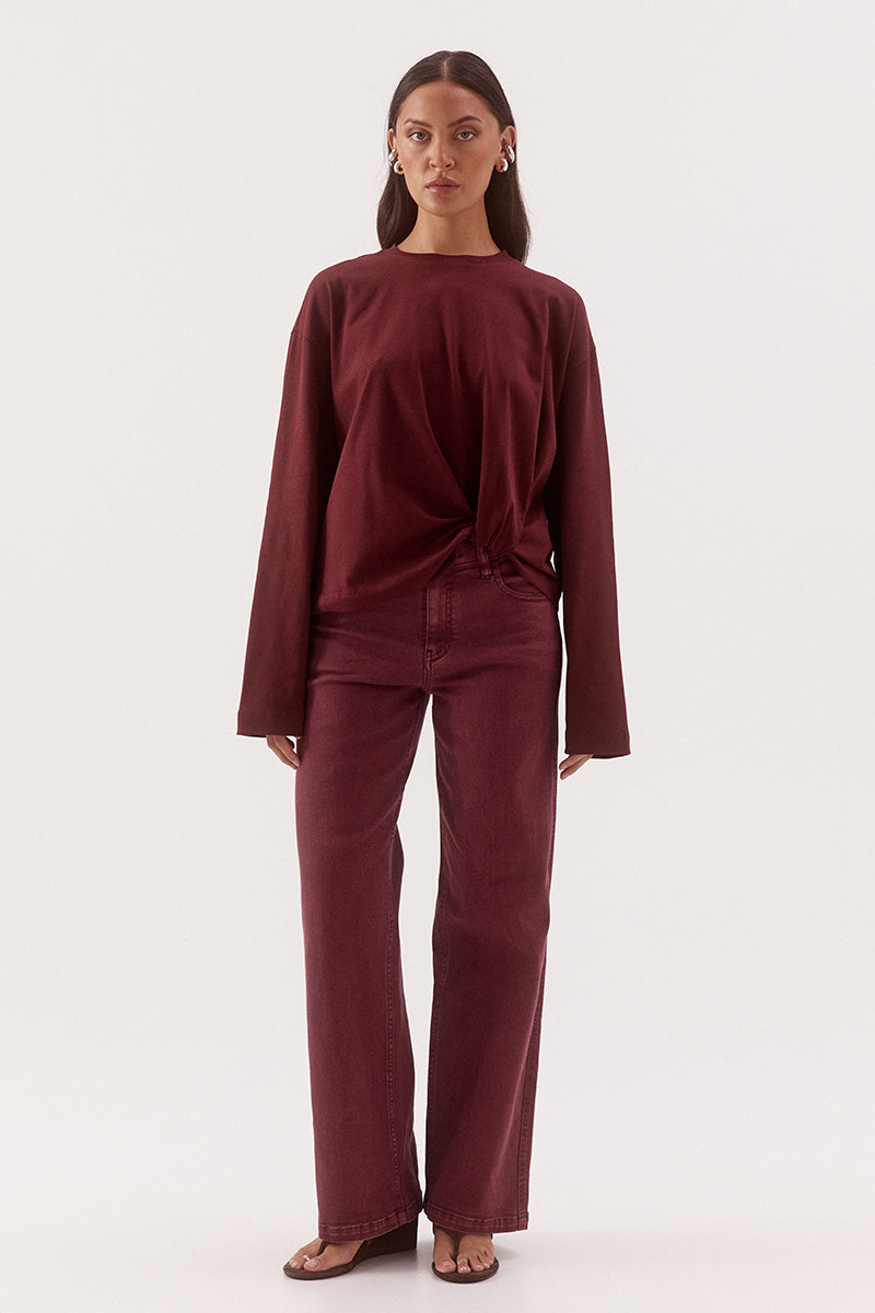 Women's oversized cotton long sleeve tee with dropped shoulders, crew neckline, and tucked front detail creating a flattering shaped hem.