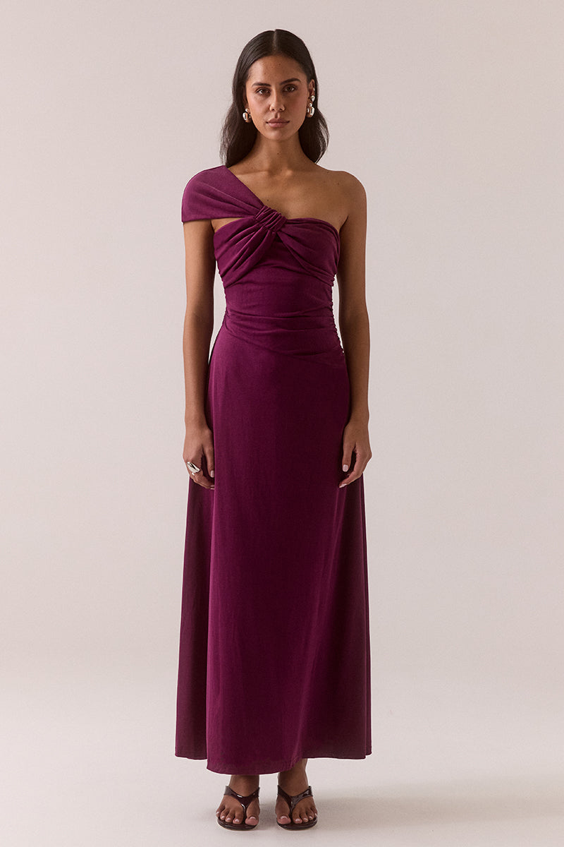 Asymmetric neckline stretch modal blend maxi dress with fitted dropped waist, gathered waist and shoulder details, internal bralette and invisible side zipper, worn by model in size 8.