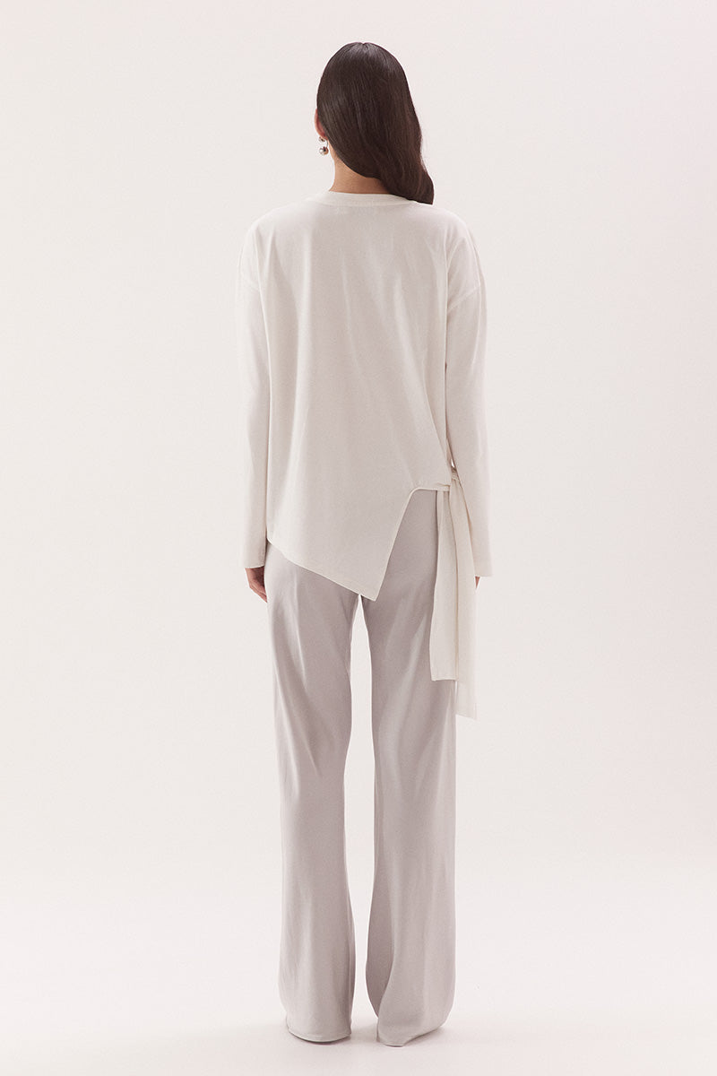 Women's oversized long sleeve cotton tee with dropped shoulders, crew neck, tie-side detail, and relaxed fit. Model wears size 8 and is 178cm tall.