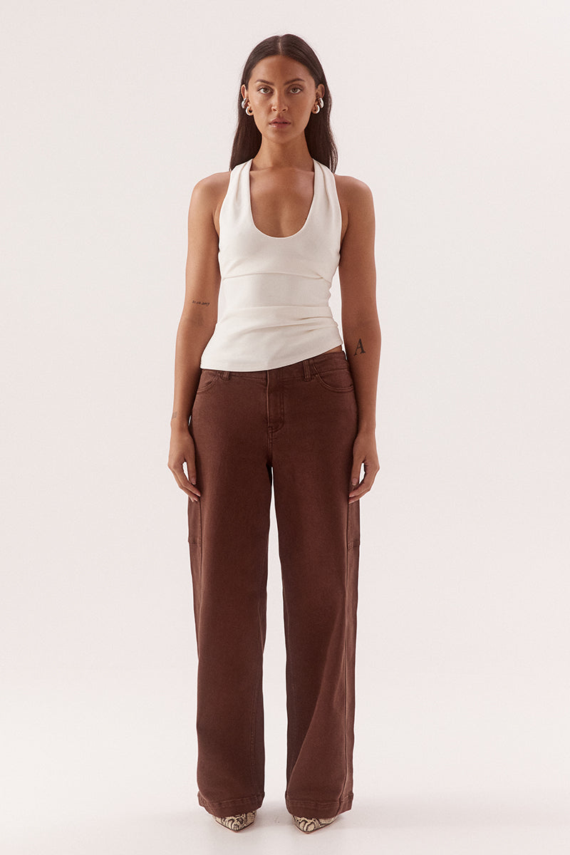Women's viscose blend sleeveless top with deep scoop neckline, racer back, shoulder tucks, asymmetric hem and stretch lining.