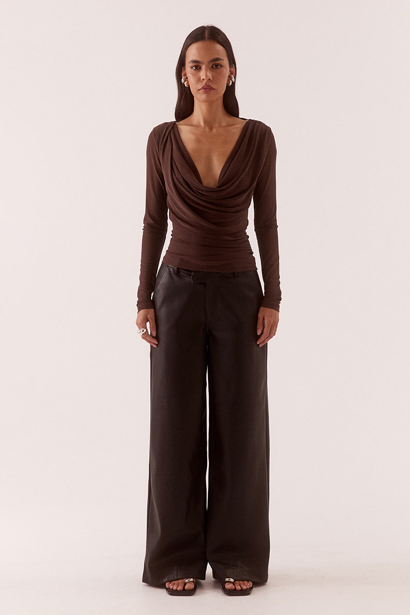 Model wearing a stretch mesh long sleeve top with deep cowl front and back neckline, gathered waist, shoulder tucks and fitted silhouette.