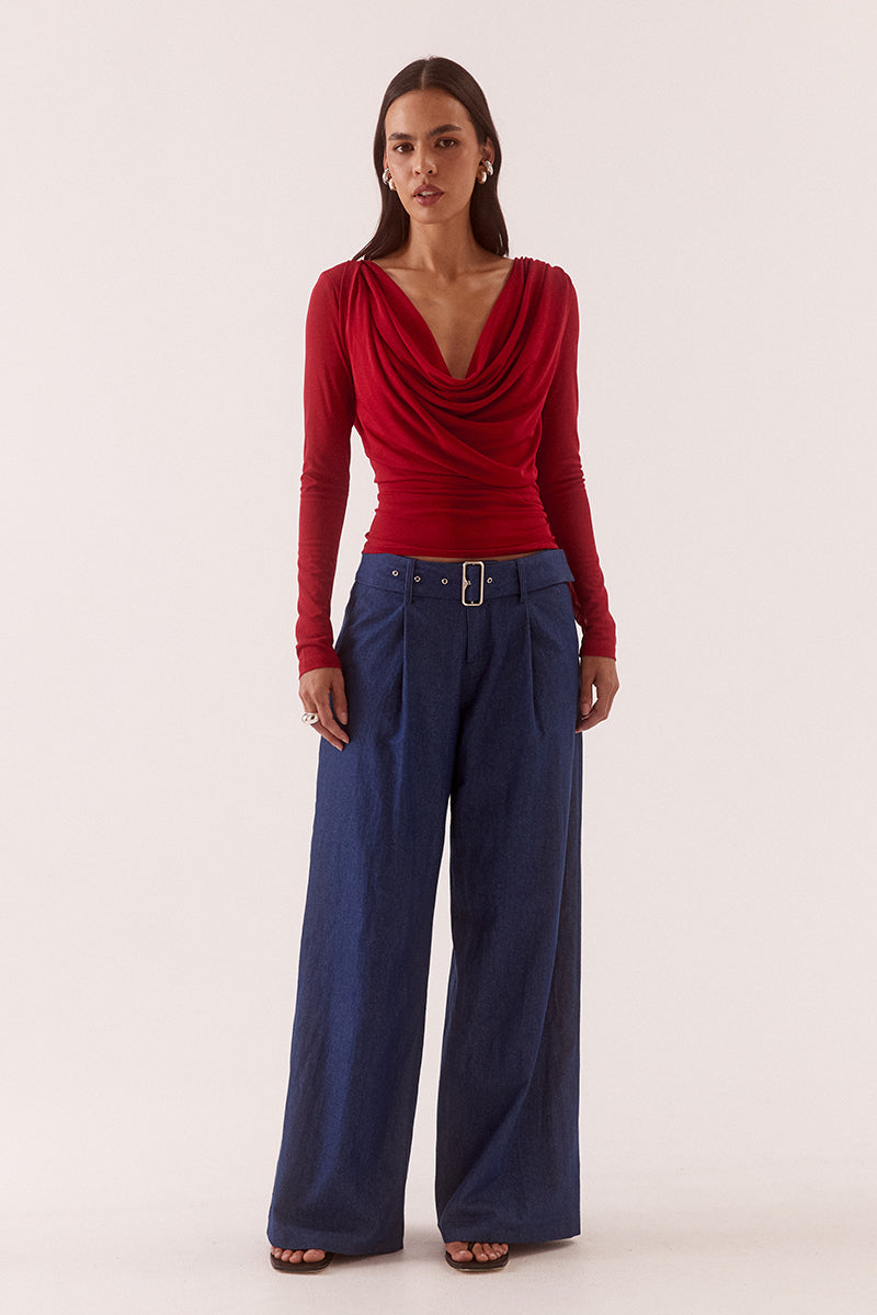 Model wearing a stretch mesh long sleeve top with deep cowl front and back neckline, gathered waist, shoulder tucks and fitted silhouette.