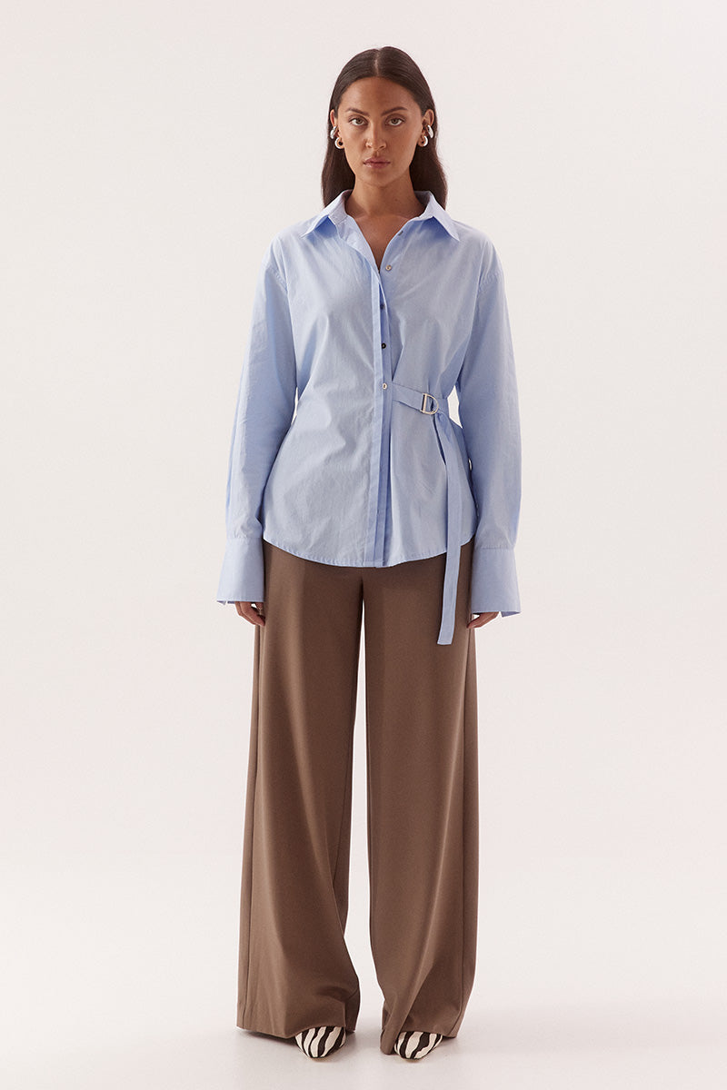 Women's relaxed fit cotton long sleeve shirt with dropped shoulders, silver metal buttons, adjustable belt detail, and side split shirtmaker hem.