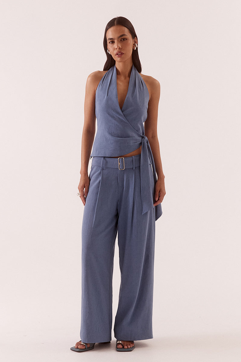 Women’s halter neck top in stretch rayon blend with wrap design, asymmetric hem, sash detail, elasticated back, and side zip closure.