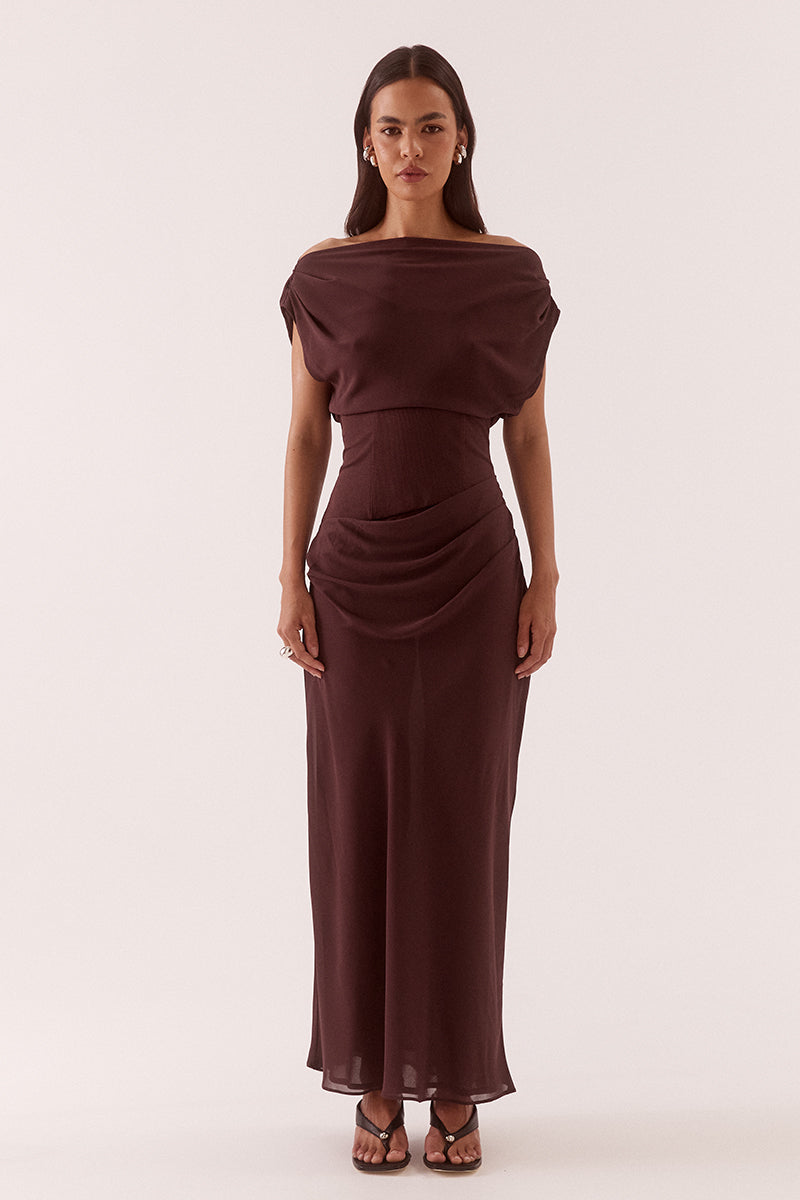 Women’s A-line maxi dress with chiffon upper, textured stretch waistband, draped overlayer skirt, boat neck neckline, long sleeves, and side zip closure.