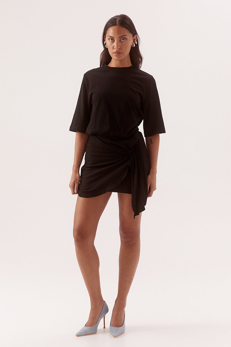 - Cotton fabrication
- Relaxed fit T- shirt mini dress
- Cinched waist
- Crew neck
- Elbow length sleeve
- Skirt overlayer has pleats pulled to one side and held by a silver metal rod
- Asymmetric hem
- Invisible zipper at side
- Length: 86cm