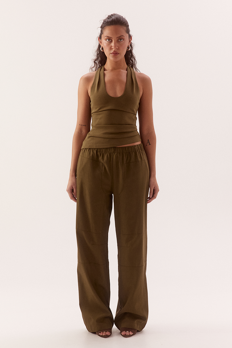 Women's viscose blend sleeveless top with deep scoop neckline, racer back, shoulder tucks, asymmetric hem and stretch lining.