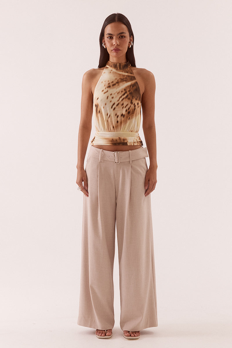 Women’s halter neck stretch mesh top with exclusive print, high neck collar, bloused bodice, gathered waistband, and back keyhole button closure.
